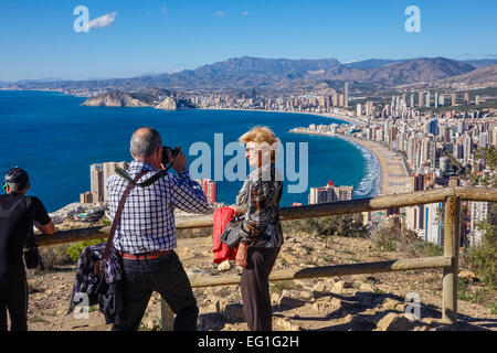 Senior couple taking photographs, and looking at the view of Benidorm, Costa Blanca, Spain. Stock Photo