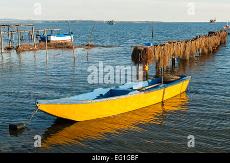 Traditional wooden boats and fishing nets in Axios Delta, near Thessaloniki, Greece. Stock Photo