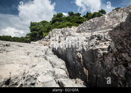 Rock formations on croatian shore where sea dwells Stock Photo