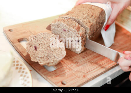 fresh bread is cut into slices on a wooden board Stock Photo