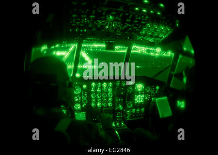 Capt. Andrew Reinhart and Lt. Col. Anthony Determan use their night vision goggles to guide their runway approach April 12, 2014, at the Sioux Falls Airport, S.D. The weekend training missions for the 96th Airlift Squadron and 27th Aerial Port Squadron included preparing and deploying airdrops, unscheduled landings, operating in night-vision environment and deploying flares. Reinhart and Determan are with the 96th Airlift Squadron.  Shannon McKay Stock Photo