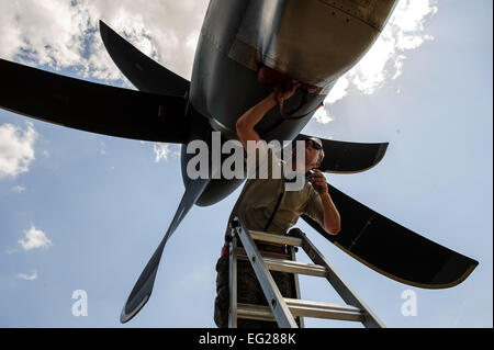 Airman 1st Class Jason Shapiro, 317th Aircraft Maintenance Squadron crew chief, inserts engine plugs into a C-130J Super Hercules after a training mission at Fort Campbell, Ky., May 20, 2014. The 39th AS can provide tactical airlift, airdrop and aeromedical evacuation, creating an air bridge for personnel, equipment and supplies. Staff Sgt. Jonathan Snyder Stock Photo