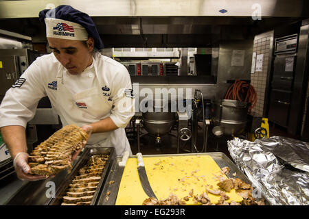 Staff Sgt. Michael Lockeart, 354th Force Support Squadron shift leader, prepares turkey for a lunch service at Eielson Air Force Base, Alaska, Aug. 4, 2014.  The dining facility feeds about 400 Airmen a day.  The 354th FSS has more than 450 assigned military and contract personnel that provide manpower, personnel services and programs to enhance morale, quality of life, personnel readiness, family support, and education and training for the Eielson AFB community.  Staff Sgt. Stephany Richards Stock Photo