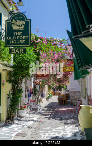 View down a traditional narrow street with small shops and bars in Skiathos Town, Skiathos Island, Greece, Europe Stock Photo