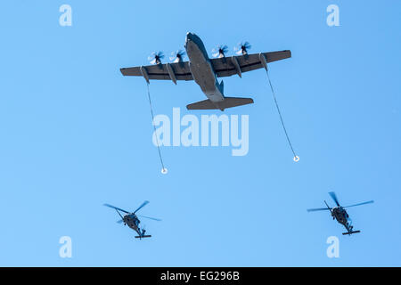 Two HH-60G Pave Hawks and an HC-130J Combat King II perform aerial refueling Feb. 28, 2014, at Moody Air Force Base, Ga. The refueling was part of a tour of Moody AFB for Secretary of the Air Force Deborah Lee James, who took over as the 23rd SECAF Dec. 20, 2013.  Airman 1st Class Ryan Callaghan Stock Photo