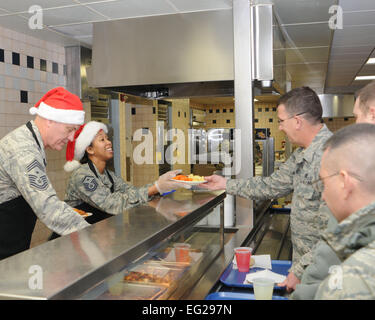Chief Master Sgt. Douglas Shepard and Master Sgt. Virginia Wynn serve a holiday meal Dec. 7, 2014, at the Community Activity Center at Youngstown Air Reserve Station, Ohio. It is a long-standing tradition for unit first sergeants to serve a holiday meal for the Airmen of the 910th Airlift Wing. Shepard is the 910th Maintenance Squadron first sergeant and Wynn is the 910th Maintenance Group first sergeant.  Tech. Sgt. Rick Lisum Stock Photo