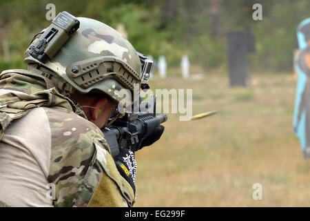 Capt. Nathan Maxton fires at a moving target Aug. 20, 2014, during the Cascade Challenge at Range 103 next to North Fort Lewis at Joint Base Lewis-McChord, Wash. Maxton is a tactical air control party member with the 3rd Air Support Operations Squadron. The participants shot the Colt M-4 carbine assault rifle and the Beretta M-9 pistol and were graded on their time of completion, and the amount of times they hit the target.  Airman 1st Class Keoni Chavarria Stock Photo