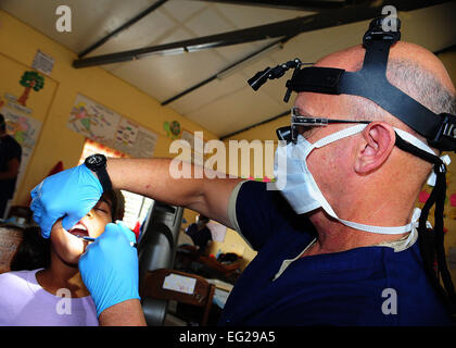 Lt. Col. Dr. Trent Payne, a dentist assigned to Maxwell Air Force Base, Ala., administers anesthesia to a Belizean girl on April 16 at the Independence Primary School in Belize. Medical professionals from the U.S. and Canada provided free medical treatment throughout Belize as part of a humanitarian assistance exercise called New Horizons.  Tech Sgt. Tony Tolley Stock Photo