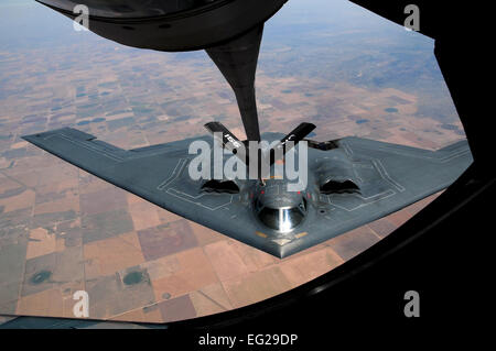 A KC-135 Stratotanker from the Nebraska Air National Guard's 155th Air Refueling Wing passes fuel to a B-2 Spirit May 22, 2012, over Southern Colorado. The KC-135, first deployed in 1956, is one of the Air Force's longest serving aircraft type. The B-2 fleet is one of the Air Force's youngest, reaching initial operational capability in 1997. Together, these two aircraft and their crews allow the Air Force to reach targets across the globe in a matter of hours.  Duncan Wood Stock Photo