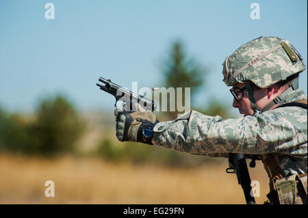 Capt. Kyle Yates provides cover during the tactics event of the Global Strike Challenge competition Sept. 24, 2014, at Camp Guernsey, Wyo. The security forces portion of the challenge was split into three different events: tactics, weapons firing and the mental and physical challenges. Yates was the 91st Security Forces Group Global Strike Challenge team leader.  Senior Airman Brittany Y. Bateman Stock Photo