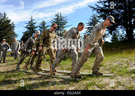 Airmen assigned to the Oregon Combat Operations Group work together during the &quot;Monster Mash&quot; field training exercise, June 22, 2013, at Camp Rilea, Ore. The focus of the training was to build unit morale, establish new professional networks and enhance military development. The event was the first time the COG, comprising four individual units, trained en masse. Air National Guard photo by Tech. Sgt. John Hughel Stock Photo