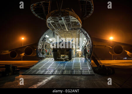 Airmen from the 9th Airlift Squadron and 455th Expeditionary Aerial Port Squadron work with Marines from the Marine Expeditionary Brigade to load vehicles into a C-5M Super Galaxy Oct. 6, 2014, at Camp Bastion, Afghanistan. Airmen and Marines loaded more than 266,000 pounds of cargo onto the C-5M as part of retrograde operations in Afghanistan.  Staff Sgt. Jeremy Bowcock