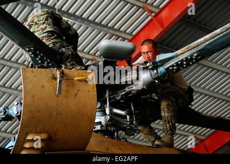 Tech. Sgt. Jin Yum and his Afghan counterpart perform a seven-day inspection on the main rotor of an Mi-17 helicopter July 17, 2012, at Kandahar Air Base, Afghanistan. Yum is a maintainer deployed with the 442nd Air Expeditionary Advisor Squadron and assigned to the 727th Special Operations Aircraft Maintenance Squadron at Cannon Air Force Base, N.M.  Staff Sgt. Quinton Russ Stock Photo