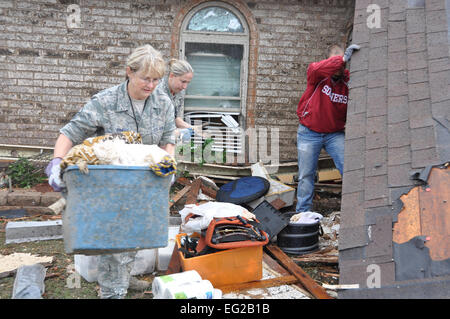 U.S. Air Force Master Sgt. Cherry Bina, 137th Maintenance Group, Oklahoma Air National Guard, recovers personal items from her house that was severely damaged after a devastating tornado hit in Moore, Okla. May 20, 2013.  Maj. Jon Quinlan Stock Photo