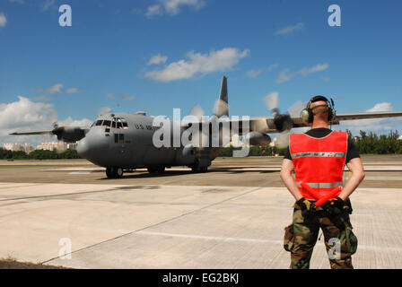 Tech. Sgt. Leon Peterson, 35th Expeditionary Airlift Squadron propulsion technician, assigned from 133rd Airlift Wing, St. Paul, Minn.,  stands ready and waiting to marshal out a C-130 in support of Operation Unified Response.  Aircrews and maintenance personnel from the Minnesota Air National Guard unit are serving at Muniz Air National Guard Base, Puerto Rico on a two-week rotation in support of the U.S. Southern Command's Coronet Oak mission.  Master Sgt. Stan Coleman Stock Photo