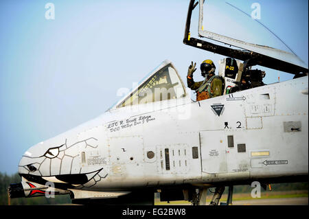 An A-10 Thunderbolt II aircraft pilot waves as he taxis down the runway during Red Flag-Alaska 13-3 Aug. 13, 2013, at Eielson Air Force Base, Alaska. Red Flag-Alaska is a series of Pacific Air Forces commander-directed field training exercises for U.S. and partner nation forces, providing combined offensive counter-air, interdiction, close-air support, and large force employment training in a simulated combat environment. The pilot is assigned to the 163rd Fighter Squadron, Indiana Air National Guard. DOD photo/Staff Sgt. Jim Araos Stock Photo