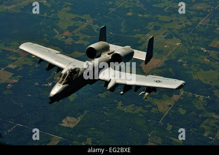 An A-10 Thunderbolt II from Selfridge Air National Guard Base, Mich., moves to take position off the right wing of a KC-135R Stratotanker, after refueling mid-air during a boss lift and training flight over Michigan on July 11, 2012. The KC-135R is from the 128th Air Refueling Wing, Milwaukee, and was conducting a refueling mission to allow recognized civilian employers who have been nominated by their guard member employees.  by Staff Sgt. Jeremy M. Wilson Stock Photo