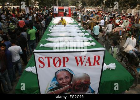 Dhaka, Bangladesh. 14th Feb, 2015. Supporters of ruling Awami League party hold placards as they protest with symbolic body bags against the ongoing nationwide blockade and strike called by the Bangladesh Nationalist Party (BNP) led alliance in Dhaka, Bangladesh, Feb. 14, 2015. At least 63 people have lost their lives due to violence in the nationwide transportation blockade that began Jan.6, to pressure Prime Minister Sheikh Hasina to resign and announce new elections. Stock Photo