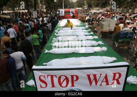 Dhaka, Bangladesh. 14th Feb, 2015. Supporters of ruling Awami League party hold placards as they protest with symbolic body bags against the ongoing nationwide blockade and strike called by the Bangladesh Nationalist Party (BNP) led alliance in Dhaka, Bangladesh, Feb. 14, 2015. At least 63 people have lost their lives due to violence in the nationwide transportation blockade that began Jan.6, to pressure Prime Minister Sheikh Hasina to resign and announce new elections. Stock Photo