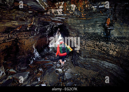 Spain, Galicia: Tourist crossing cave at  Cathedral´s beach Stock Photo