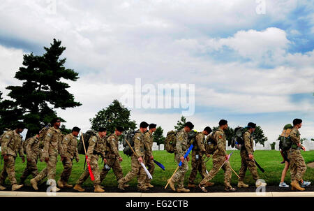 Tactical Air Control Party Airmen from the 13th Air Support Operations Squadron, Ft. Carson, Co. ruck through Arlington National Cemetery during the final leg of their 140-mile ruck to honor their fallen commander, Maj. David Gray, who was killed in Afghanistan last year, Aug. 7, 2013. The Airmen are marching from Dover Air Force Base, Del., the receiving point for deceased service members killed in war, to Arlington National Cemetery, to Gray’s gravesite. Senior Airman Lauren Main Stock Photo