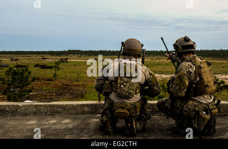 A U.S. Air Force Tactical Air Control Party member right points at a target in the field to a U.S. Air Force Combat Controller while participating in close air support training during Emerald Warrior 2014 on Hurlburt Field, Fla., May 1, 2014. Emerald Warrior is an annual, joint exercise to train special operations, conventional and partner nation forces in combat scenarios designed to hone special operations air and ground combat skills, and is the Department of Defense's only irregular warfare exercise.  Senior Airman Colville McFee / Released Stock Photo