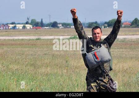 A Bulgarian paratrooper celebrates after landing from a wing exchange jump where he used an American parachute July 17, 2013, in Plovdiv, Bulgaria. American and Bulgarian paratroopers exchanged parachutes for the opportunity to conduct a wing exchange at the end of Thracian Summer.  Airman 1st Class Trevor Rhynes Stock Photo