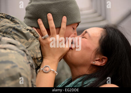 Capt. Joe Faraone reunites with his wife, Suk, Jan. 15, 2014, at Spangdahlem Air Base, Germany, The Airman returned from a deployment to Southwest Asia in support of Operation Enduring Freedom. Faraone serves with the 606th Air Control Squadron.  Airman 1st Class Kyle Gese Stock Photo