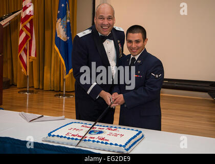 In keeping with tradition, Brig. Gen. Michael Brewer, 412th Test Wing commander and highest ranking officer attending the dinner, cuts the U.S. Air Force birthday cake with Airman Juan Bonilla, 412th Aerospace Medicine Squadron, the lowest ranking and youngest Airman in attendance. Team Edwards celebrated the Air Force's 67th birthday with a formal dinner at Club Muroc on Edwards Air Force Base, Calif., Sept. 12. The Air Force's official birthday is Sept. 18.  Bobbi Zapka Stock Photo