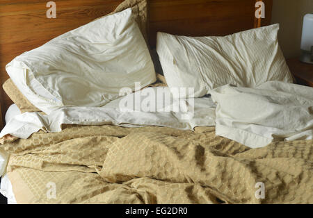 An unmade double bed. Stock Photo