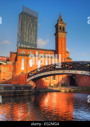 Castlefields in Manchester, UK, canal basin and tourist attraction containing pubs and restaurants; Hilton hotel in background Stock Photo
