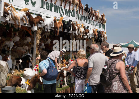 On a hot sunny day, people are milling around a trade stand selling & displaying cute cuddly toys - The Great Yorkshire Show - Harrogate, England, UK. Stock Photo