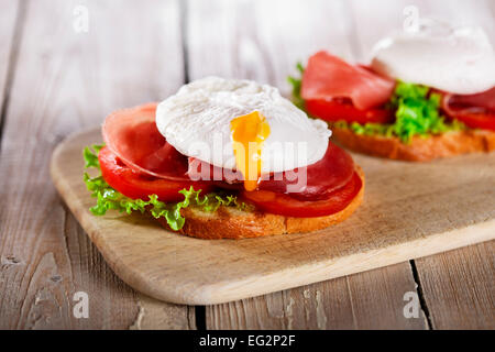 sandwich with prosciutto and poached egg tomato Stock Photo