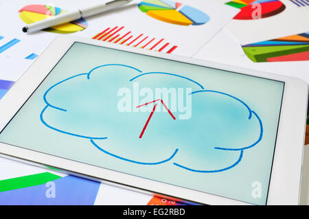 a drawing of a cloud with an arrow inside on the screen of a tablet, depicting the concept of upload to the cloud storage Stock Photo