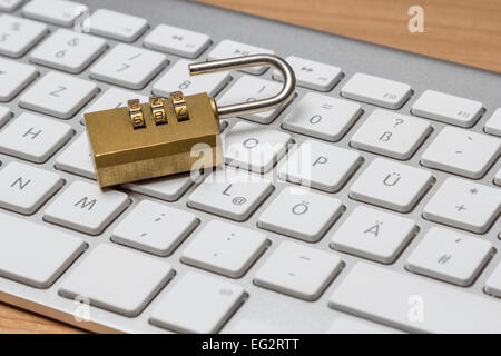 Modern silver keyboard with bress combination lock Stock Photo