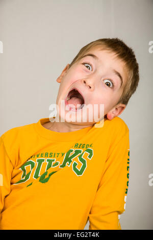 Six year old boy acting silly and making a funny face Stock Photo