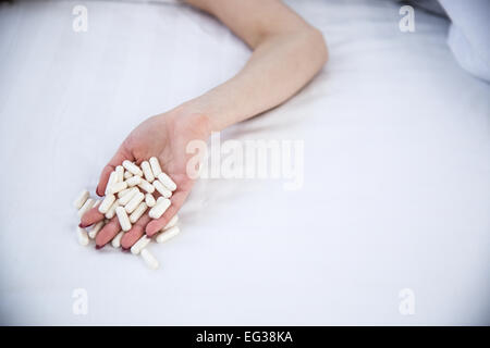 Closeup image of a female hand holding pills