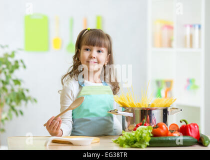 kid girl playing cook and preparing spaghetti Stock Photo