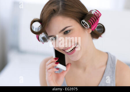 Portrait of a happy woman talking on the phone at home Stock Photo