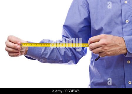 Male worker's hand holding Self-retracting  tape mesaure meter. Part of series set of images with DIY tools for home jobs Stock Photo