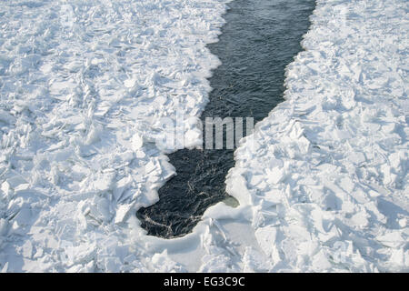 Detailed photo of frozen St-Lawrence River in Montreal, with crumbled ice spikes and free water Stock Photo