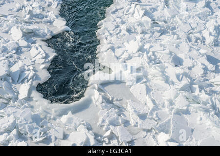 Detailed photo of frozen St-Lawrence River in Montreal, with crumbled ice spikes and free water Stock Photo