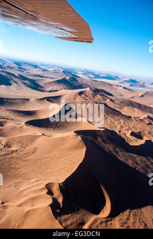 Aerial View, including the wing of small plane, over Sand Dunes in Sossusvlei, Nabib-Naukluft National Park, Namibia, Africa Stock Photo