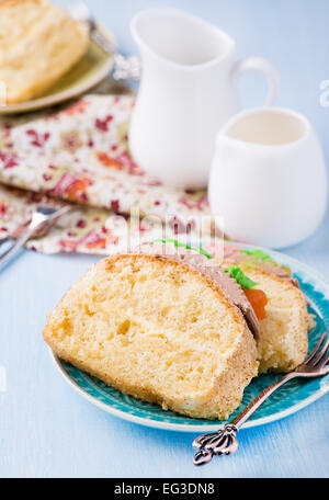 Slices of sponge cake with buttercream on plate served for tea, selective focus Stock Photo