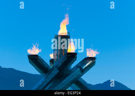 The Olympic Cauldron burns in Coal Harbour, Vancouver,Canada during 2010 Winter Olympic Games against beautiful blue sky. Stock Photo
