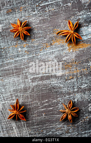 Vertical food background with four star anise close up on vintage black table. Selective focus. Space for text, great for menu. Stock Photo