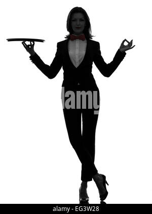 one  woman waiter butler holding empty tray zen gesturing in silhouette on white background Stock Photo