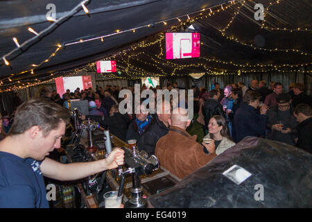 Rugby fan & barman staff at marquee bar. The Smokeshack / THE PUB / public house. Twickenham UK; popular with fans on match days Stock Photo