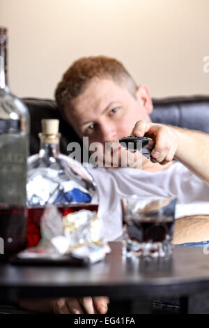lazy man flips channels on tv Stock Photo