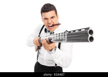 Aggressive man threatening with a shotgun isolated on white background Stock Photo